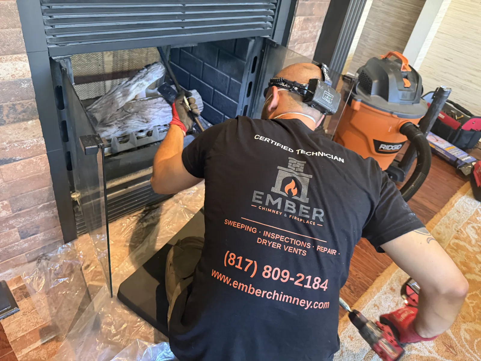 Ember technician servicing a fireplace with pro tools