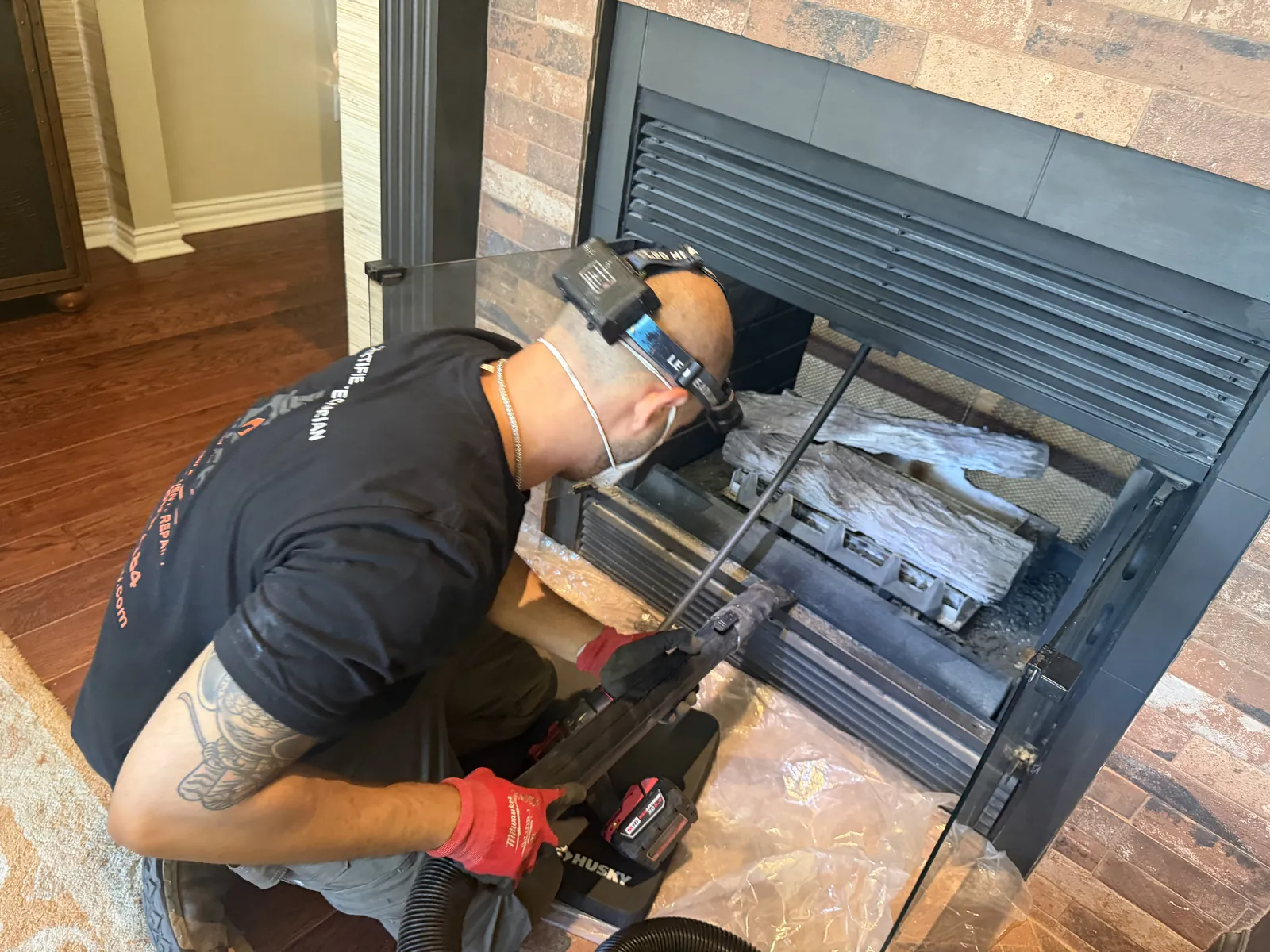 Ember technician sweeping a gas fireplace from the side