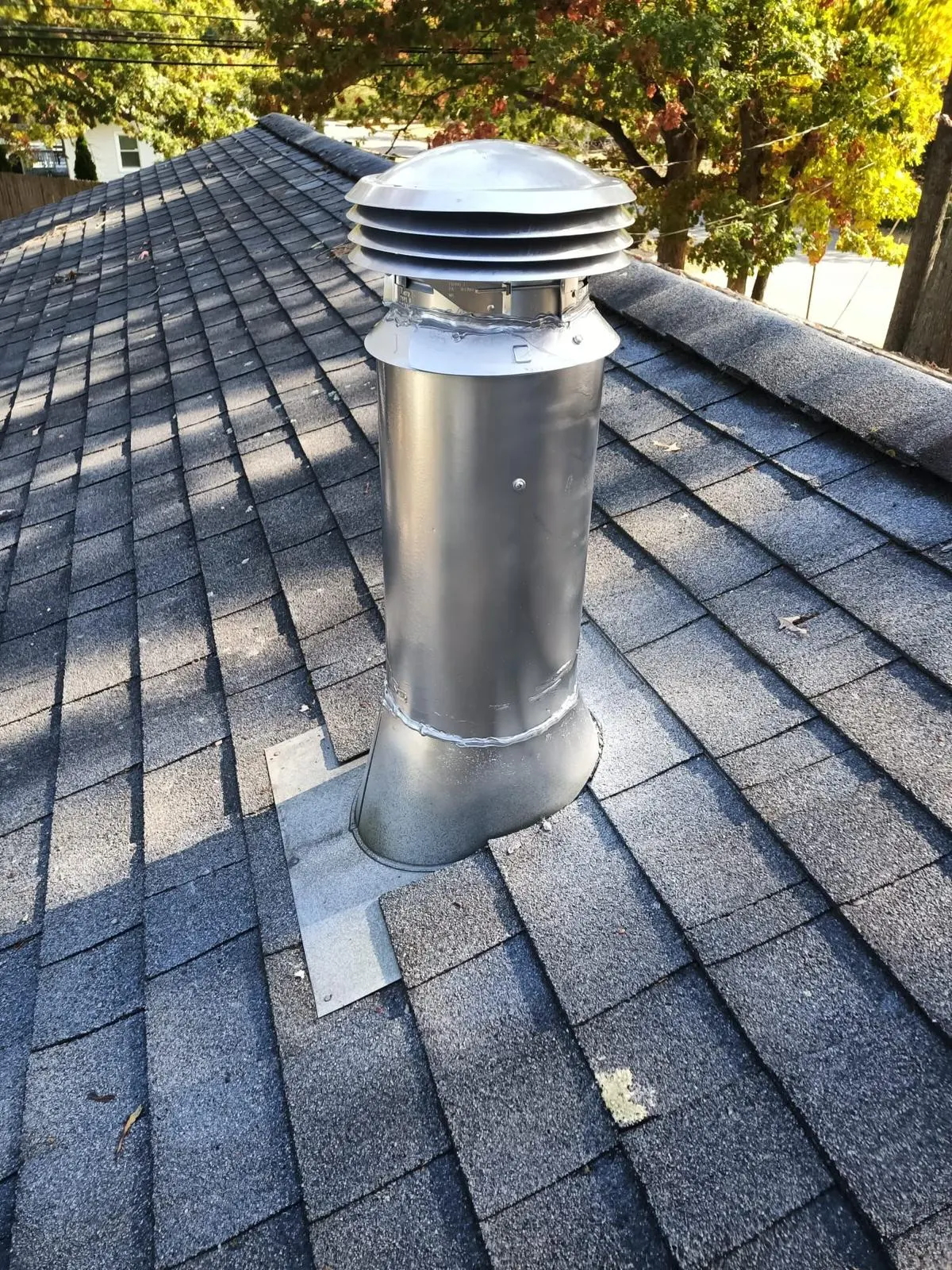 Stainless chimney cap on a roof