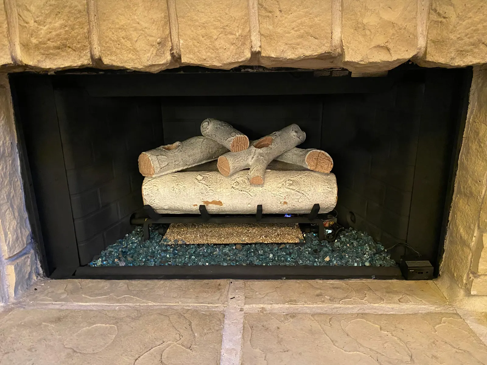 Gas log set in a stone fireplace
